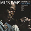 Album cover for Miles Davis' 'Kind of Blue' on Columbia Records, featuring a dramatic close-up photograph of the jazz musician playing a saxophone against a dark background, with the title and artist name in large white and blue text.