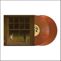 A vinyl record package shown on a plain white background: a square album cover featuring a window scene with two children running outdoors, next to two translucent reddish-brown records with a circular black-and-white label.