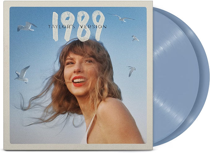 Vinyl record with a cover featuring a person and the text '1989 Taylor's Version' against a blue sky with birds, the crystal blue vinyl is displayed protruding from the sleeve.