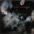 The Cure - Disintegration album cover artwork, featuring a dark, surreal collage with a woman's face, flowers, and the album title in red text near the top.