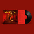 Vinyl record with a red cover featuring the text 'skinty fie' on a red background